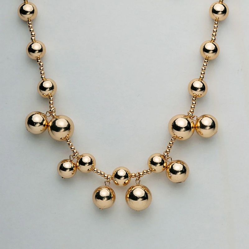 Halsband Bead multi i guld från Bow19 med hängande guldfärgade pärlor.
