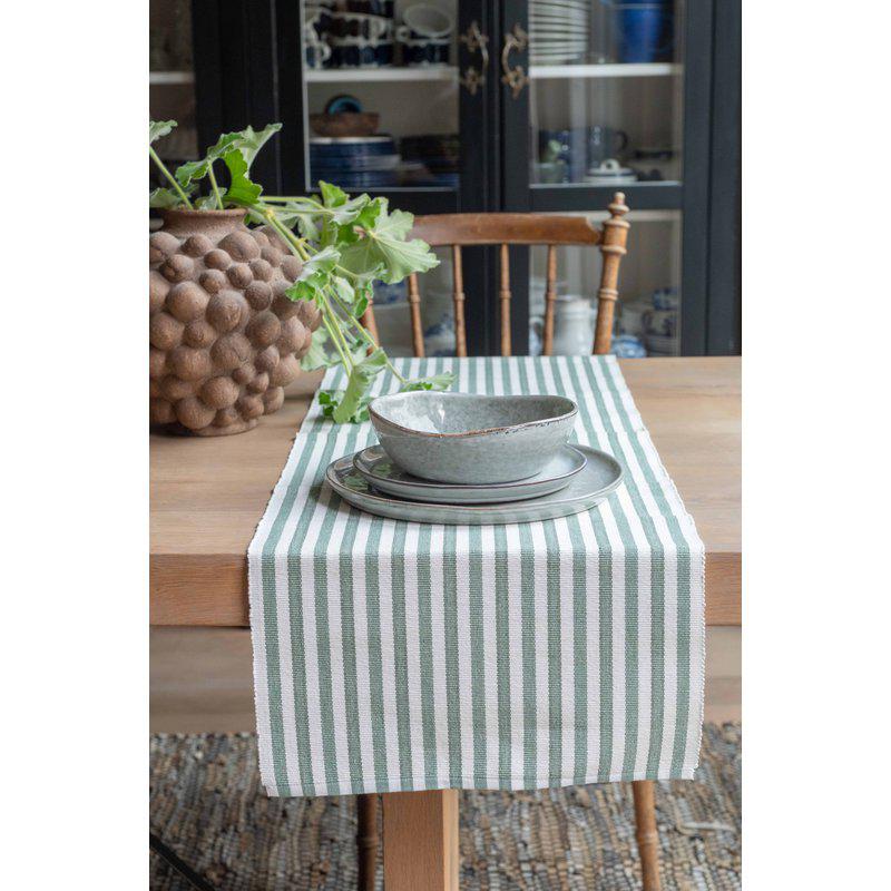 Randig löpare kallad Nina i grön/vit från Fondaco på ett dukat bord.